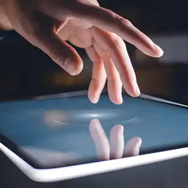 Close-up of hand using a touchscreen interface for interactive event engagement in San Diego
